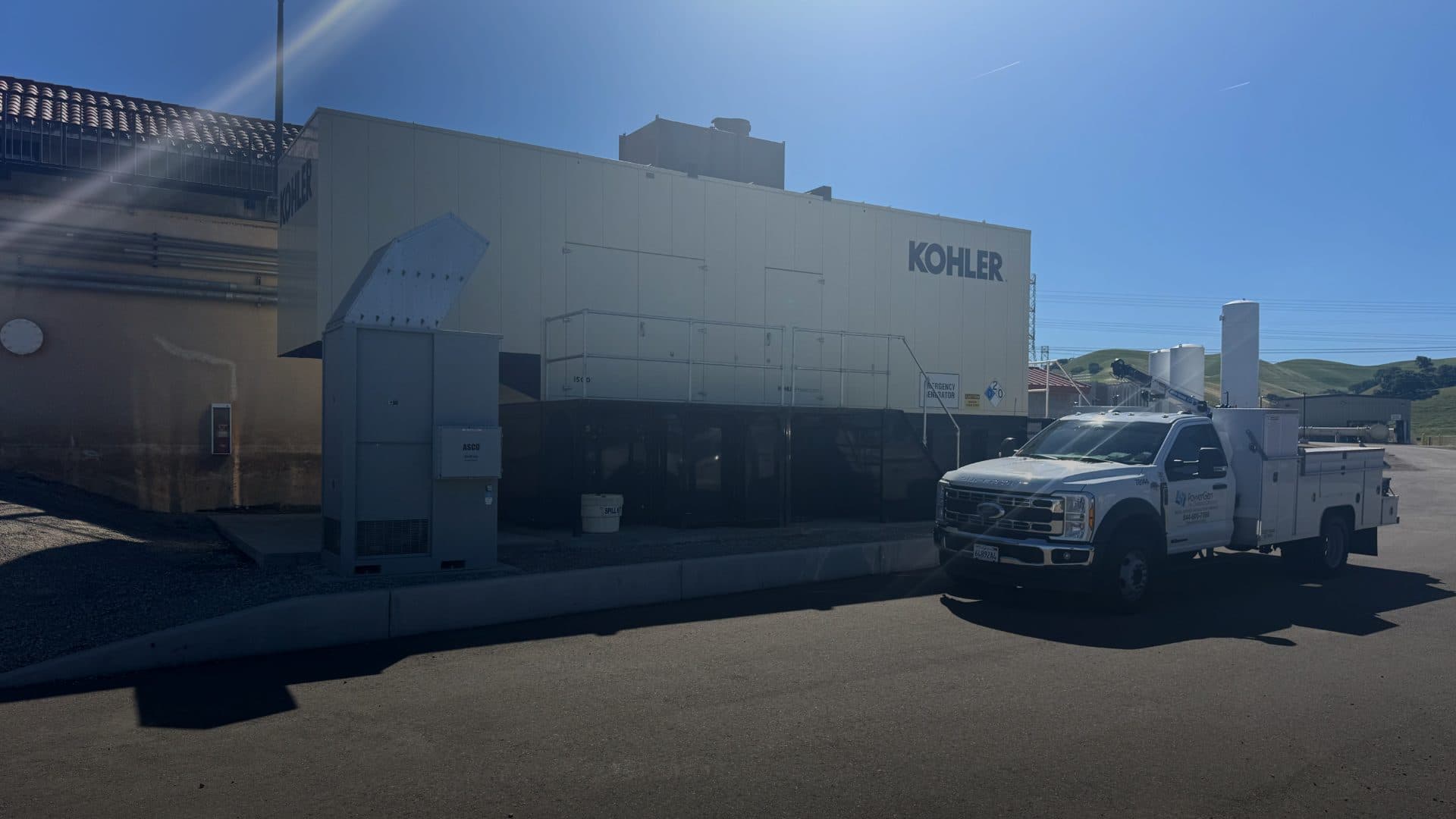PowerGen service truck and technician at a commercial generator installation