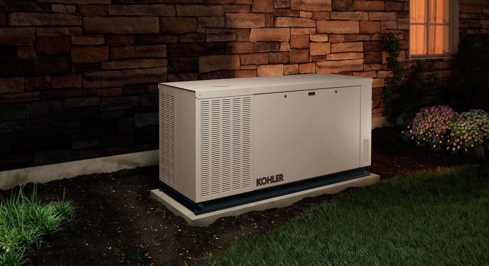 Kohler residential standby generator installed beside a home at dusk
